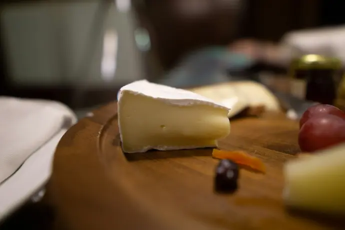 sliced cheese on brown wooden chopping board